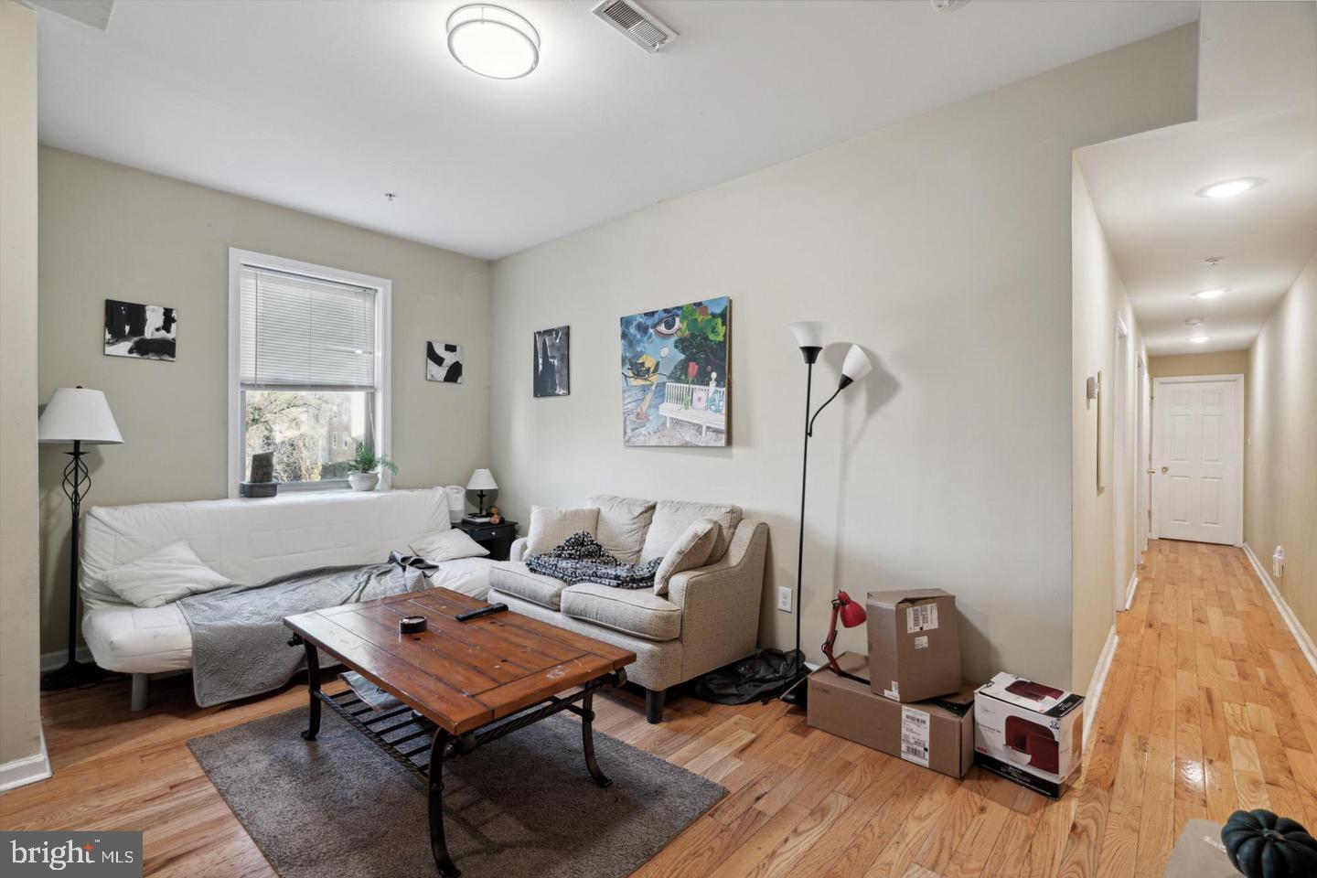 1611 North 17th Street, Unit B Philadelphia, PA 19121 - Photo 1 of 10 a living room with furniture a rug and a lamp