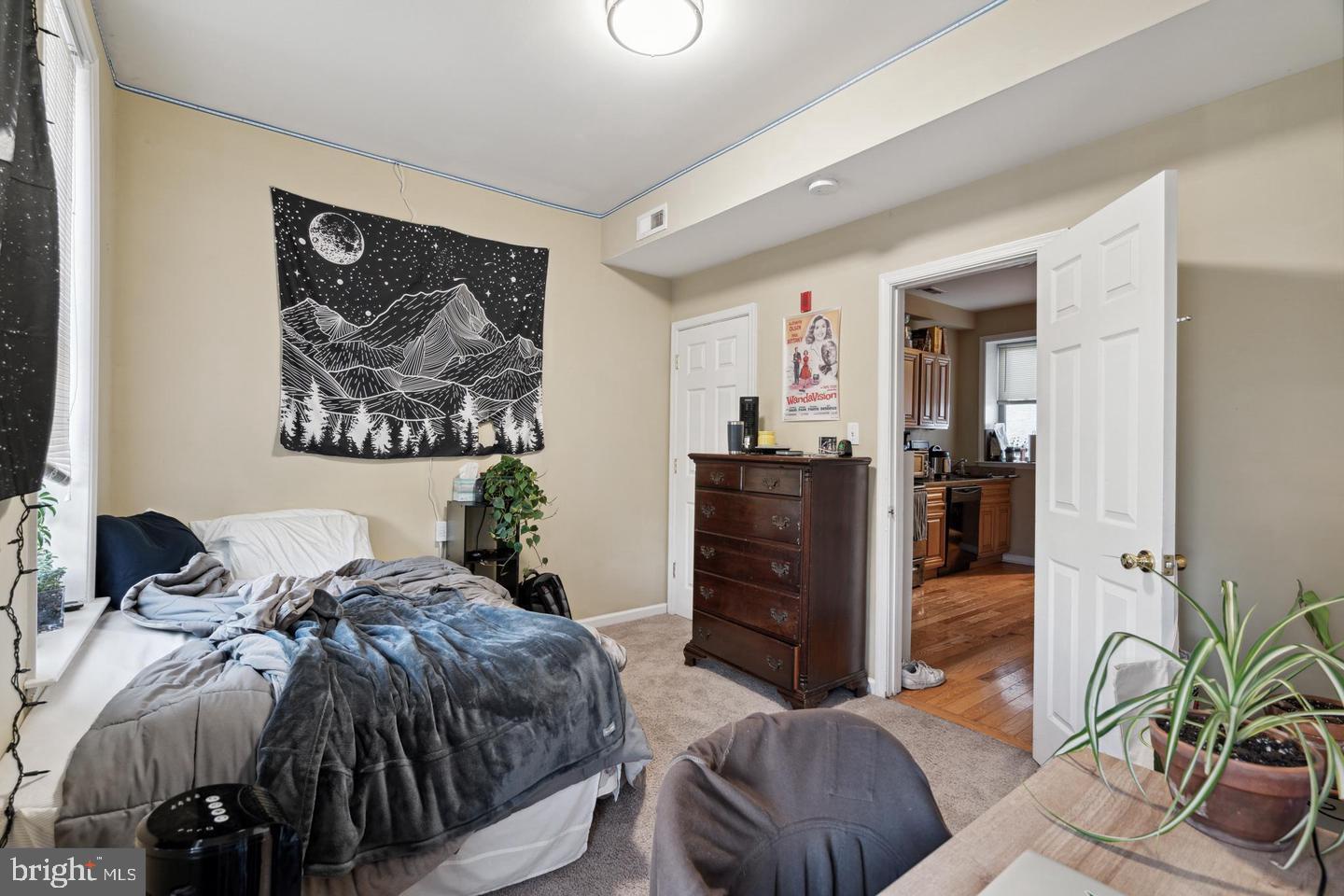 1611 North 17th Street, Unit B Philadelphia, PA 19121 - Photo 6 of 10 a bed room with a bed and a chair