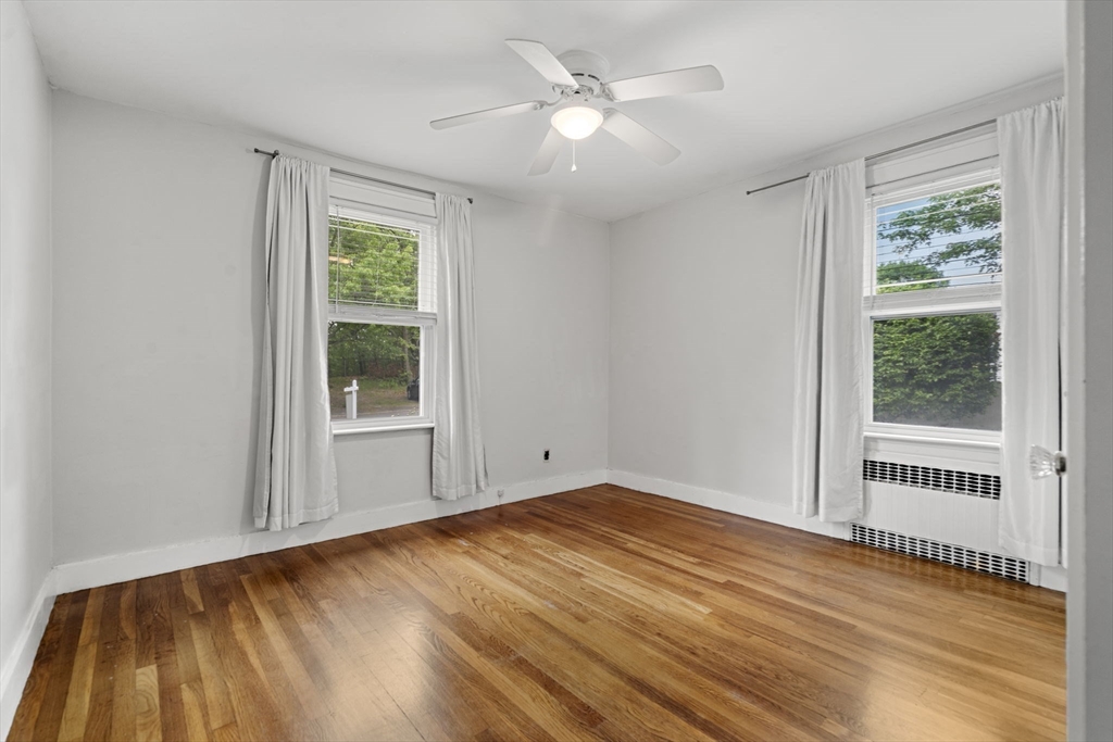 5 Walker Avenue Andover, MA 01810 - Photo 11 of 23 a view of an empty room with a window and wooden floor