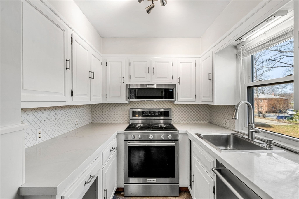 5 Walker Avenue Andover, MA 01810 - Photo 2 of 23 a kitchen with cabinets appliances and a window
