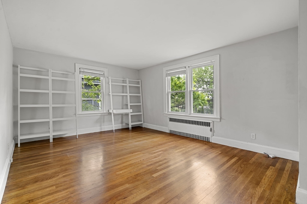 5 Walker Avenue Andover, MA 01810 - Photo 7 of 23 a view of an empty room with a window and wooden floor