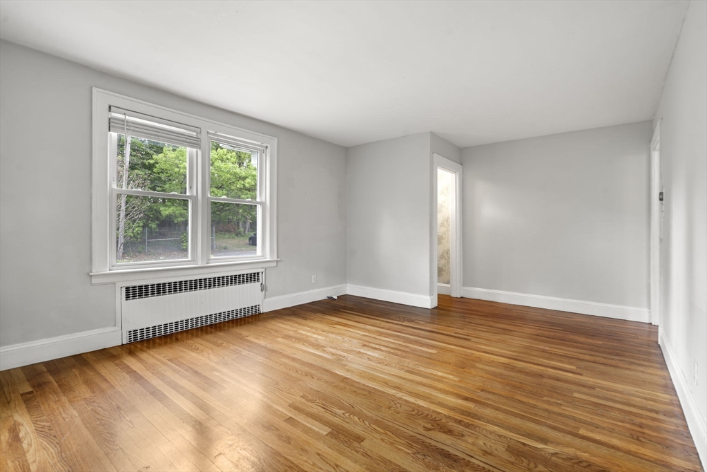 5 Walker Avenue Andover, MA 01810 - Photo 8 of 23 a view of an empty room with wooden floor and a window