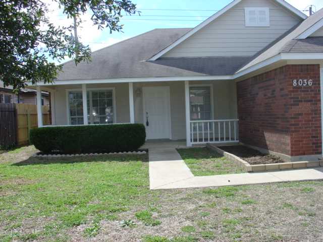 a view of front door and small yard