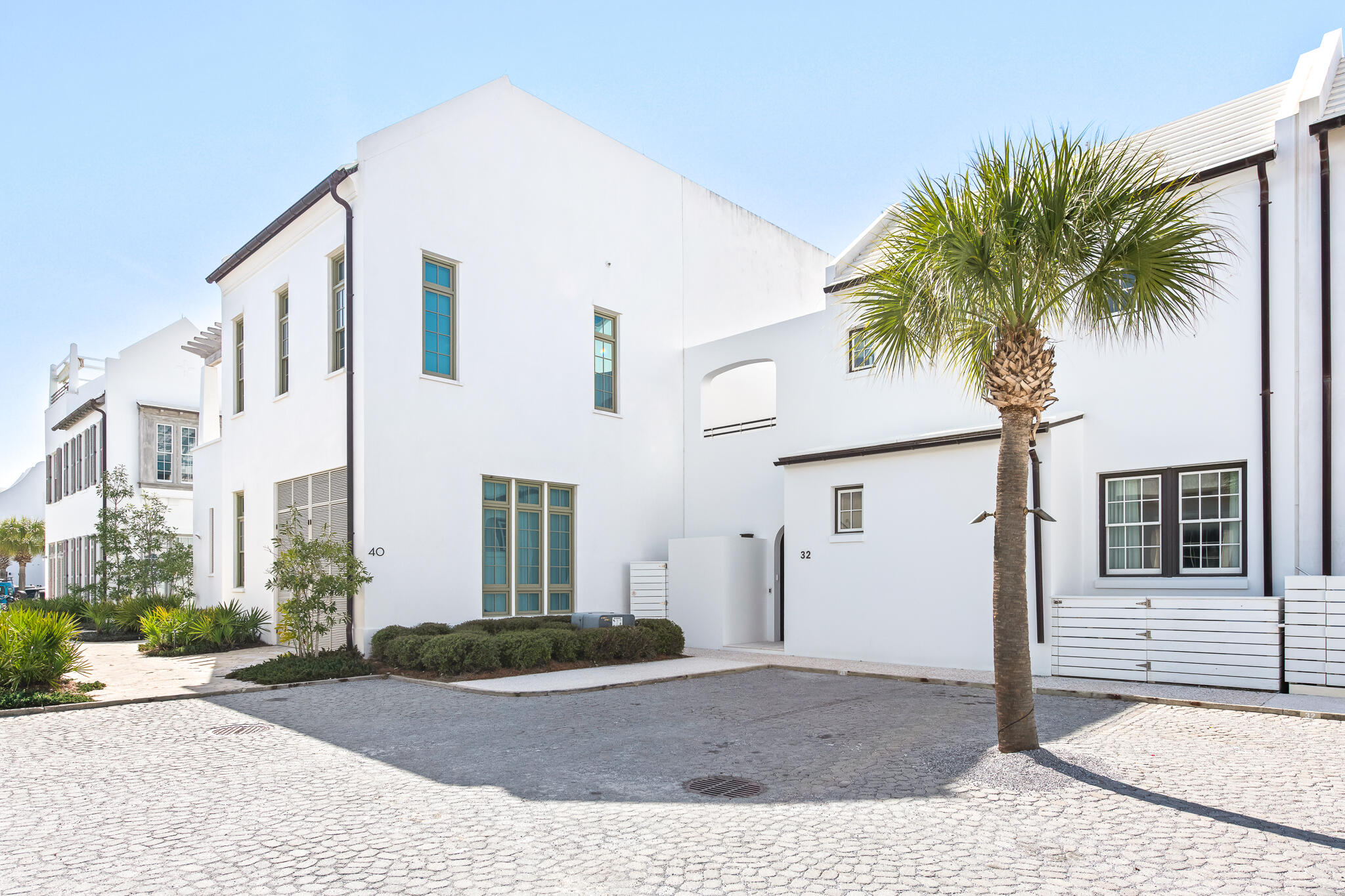 32 Kings Castle Ct Inlet Beach Inlet Beach, FL 32461 - Photo 56 of 66 a front view of a house with garage and plants