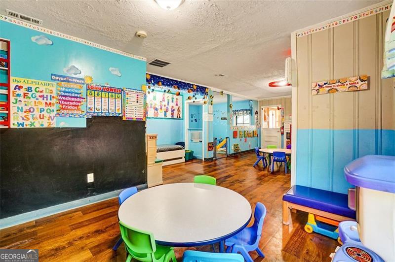 5099 Austell Powder Springs Road Austell, GA 30106 - Photo 12 of 38 a living room with furniture a rug and a painting on the wall