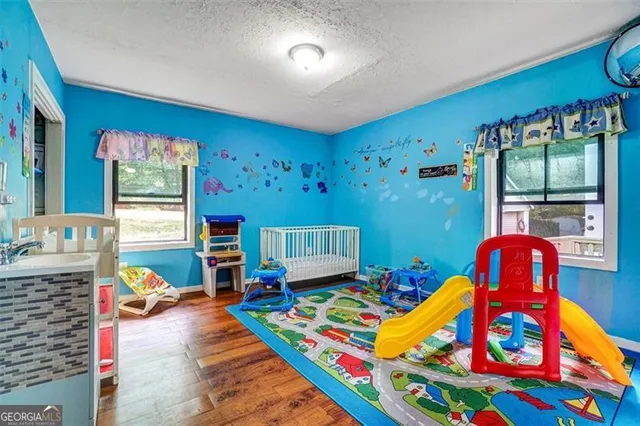 a living room with furniture fireplace and dining table