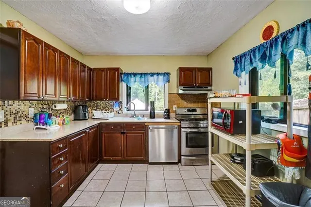 a kitchen with stainless steel appliances a refrigerator and cabinets