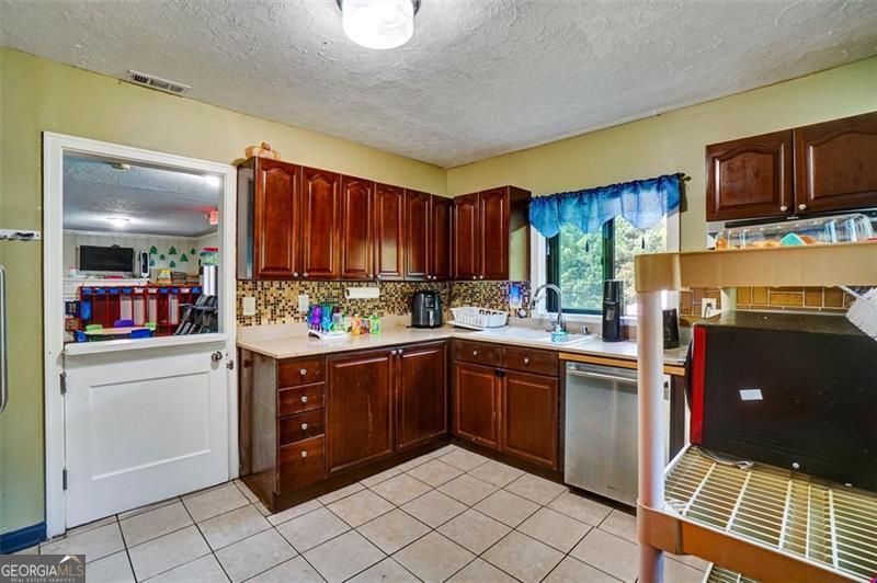 5099 Austell Powder Springs Road Austell, GA 30106 - Photo 21 of 38 a kitchen with stainless steel appliances granite countertop a refrigerator and a stove top oven