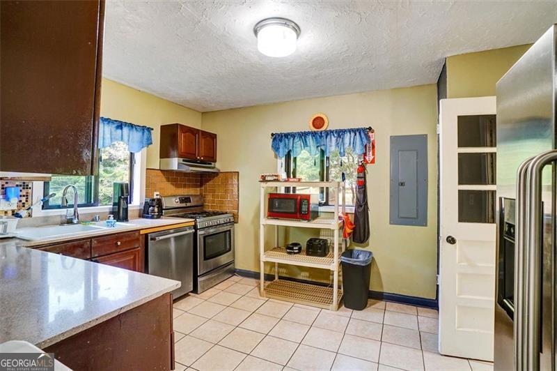 5099 Austell Powder Springs Road Austell, GA 30106 - Photo 22 of 38 a kitchen with stainless steel appliances granite countertop a refrigerator and a stove top oven