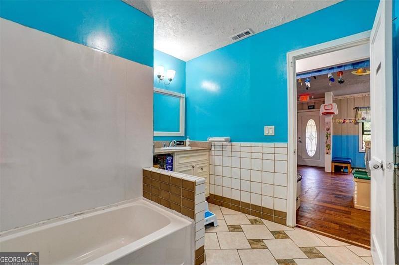 5099 Austell Powder Springs Road Austell, GA 30106 - Photo 23 of 38 a bathroom with a bathtub and shower