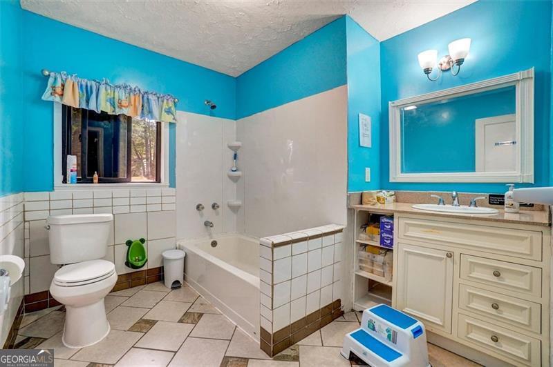 5099 Austell Powder Springs Road Austell, GA 30106 - Photo 24 of 38 a bathroom with a sink a toilet and a bathtub