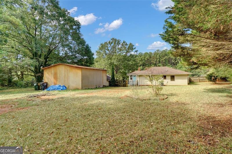 5099 Austell Powder Springs Road Austell, GA 30106 - Photo 28 of 38 a front view of a house with yard and trees