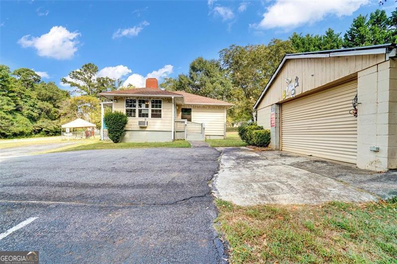 5099 Austell Powder Springs Road Austell, GA 30106 - Photo 29 of 38 a front view of a house with a yard and garage
