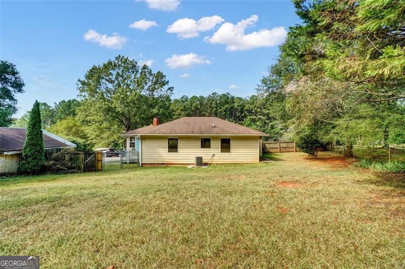 5099 Austell Powder Springs Road Austell, GA 30106 - Photo 30 of 38 a white house that has a tree in front of it