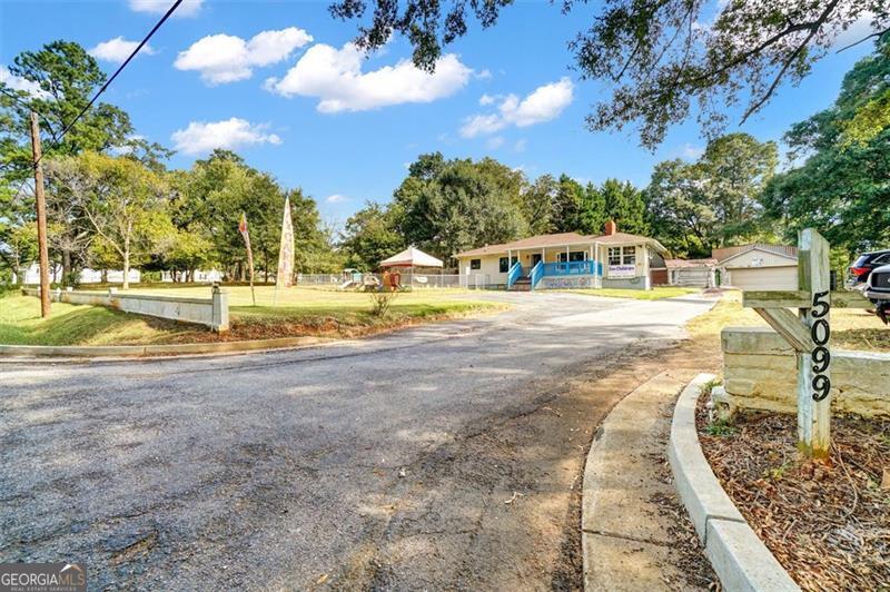 5099 Austell Powder Springs Road Austell, GA 30106 - Photo 3 of 38 a view of a swimming pool with an outdoor seating