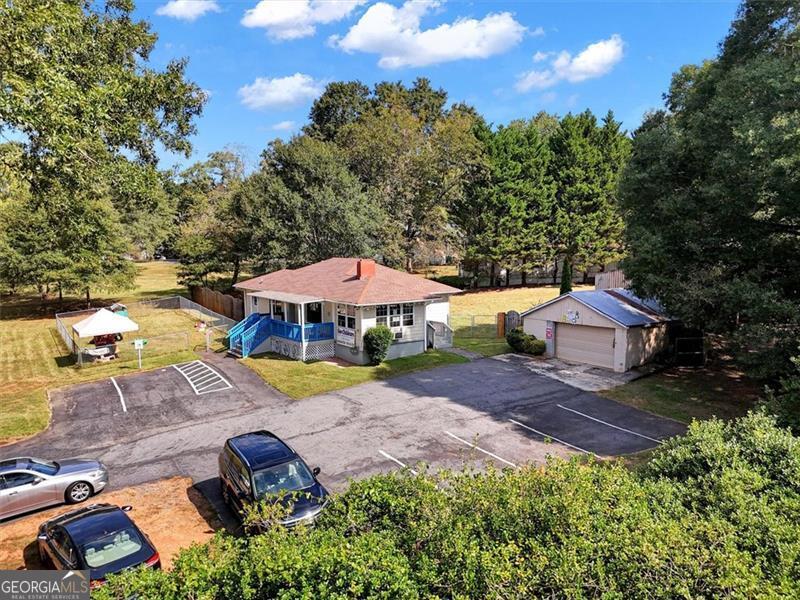 5099 Austell Powder Springs Road Austell, GA 30106 - Photo 33 of 38 an aerial view of a house with garden space and trees