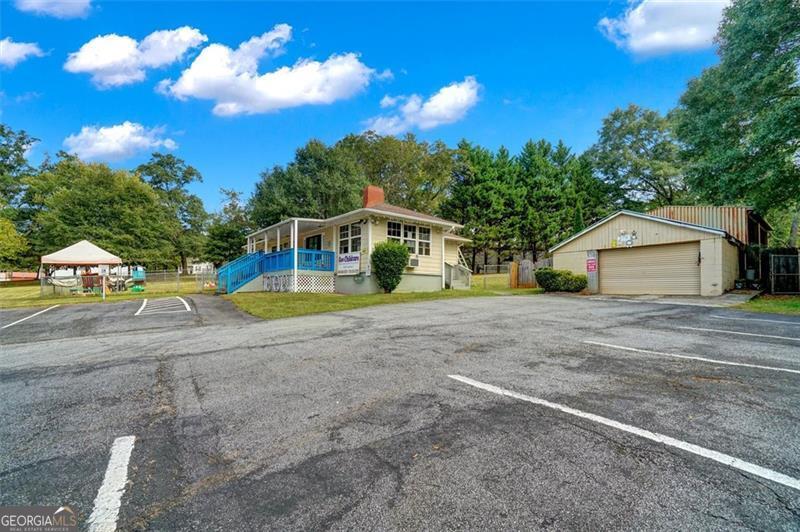 5099 Austell Powder Springs Road Austell, GA 30106 - Photo 35 of 38 a view of a house with a yard and sitting area