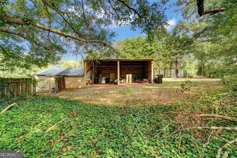 5099 Austell Powder Springs Road Austell, GA 30106 - Photo 36 of 38 a view of a house with backyard and trees