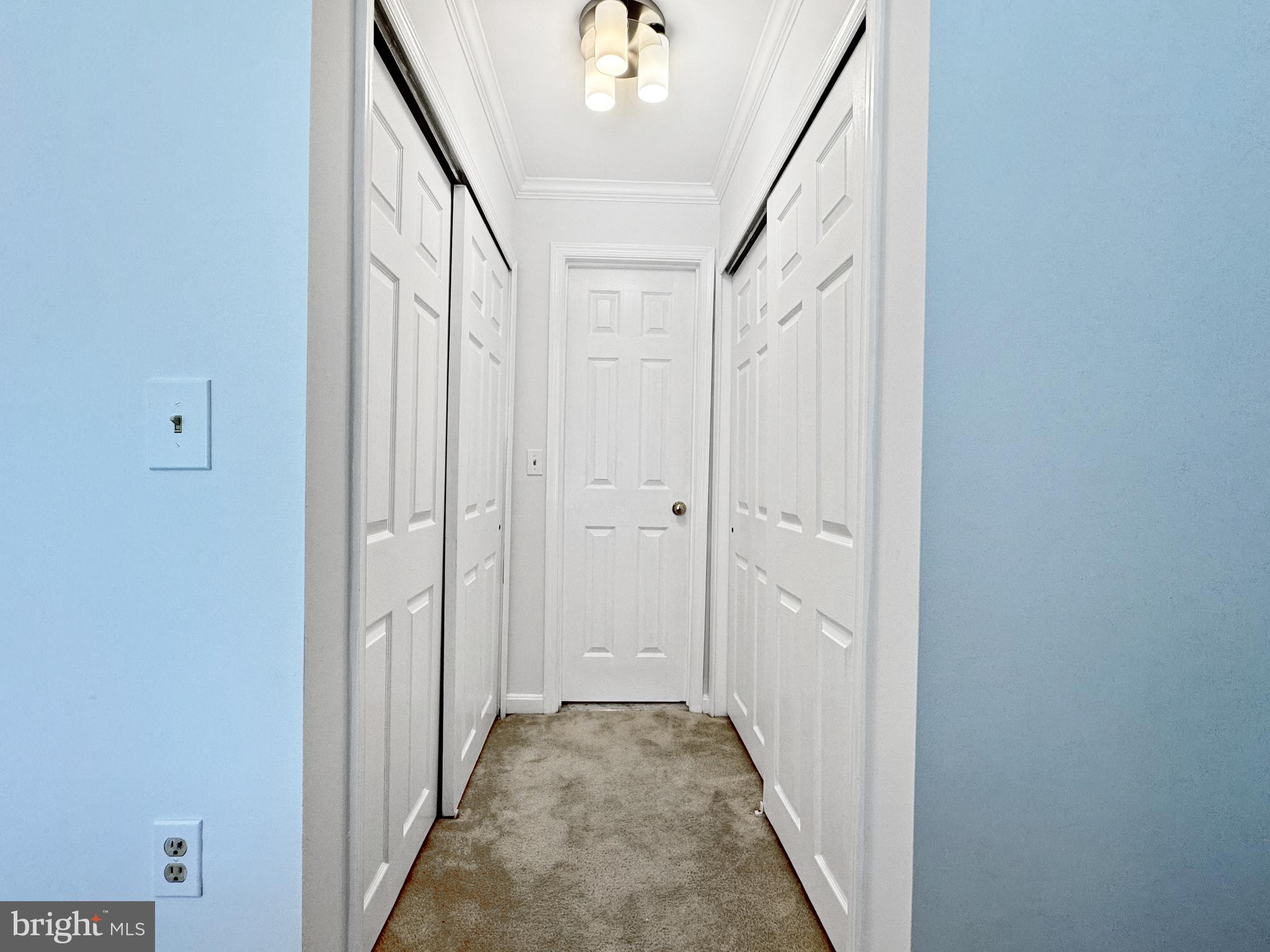 103 Timberbrook Lane, Unit 104 Gaithersburg, MD 20878 - Photo 11 of 35 a view of a hallway with white walls and stairs