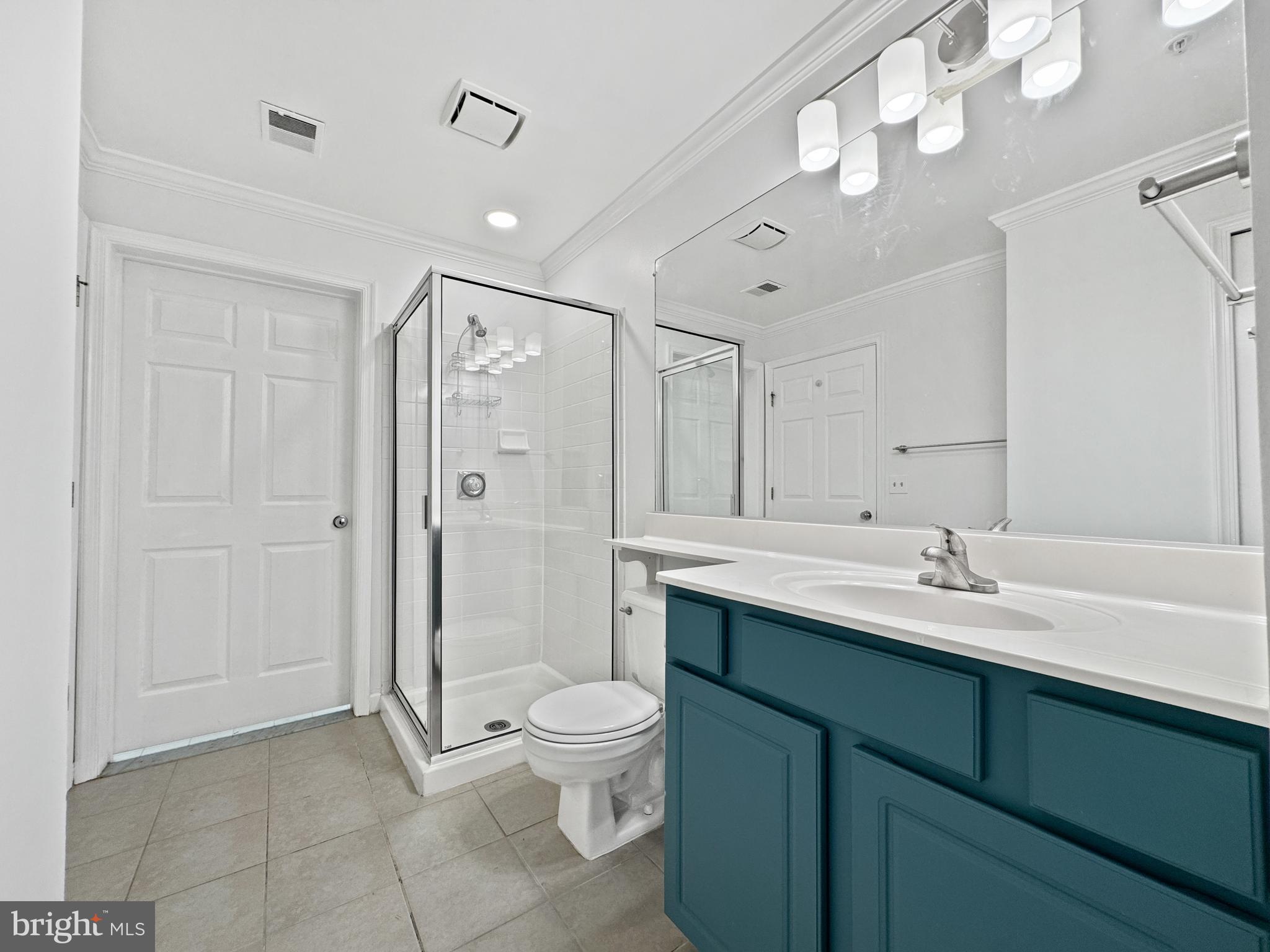 103 Timberbrook Lane, Unit 104 Gaithersburg, MD 20878 - Photo 13 of 35 a bathroom with a sink a toilet and a large mirror