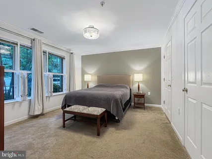 a bedroom with a bed and large window