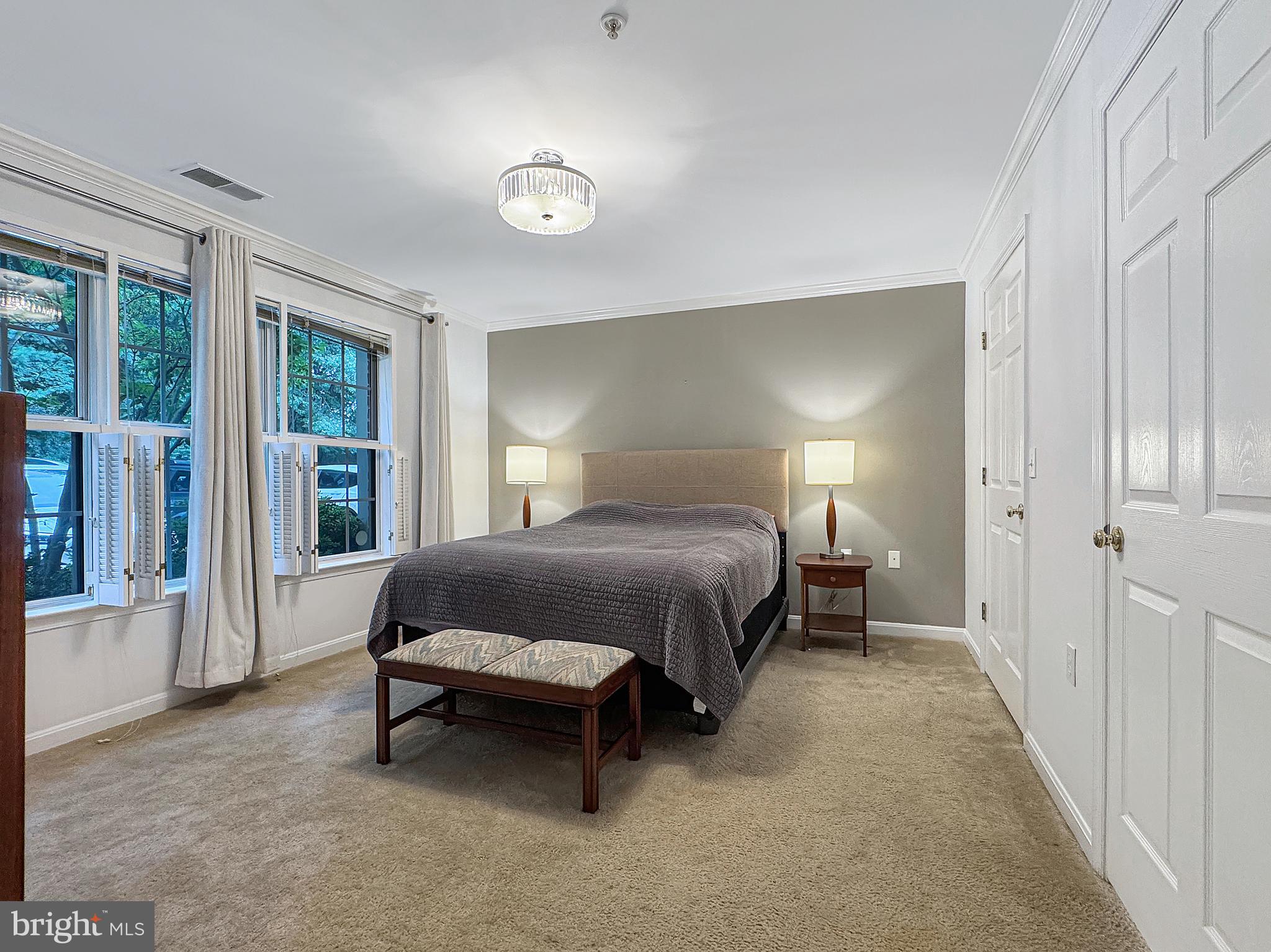 103 Timberbrook Lane, Unit 104 Gaithersburg, MD 20878 - Photo 15 of 35 a bedroom with a bed and large window