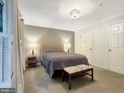 a spacious bedroom with a bed and a lamp