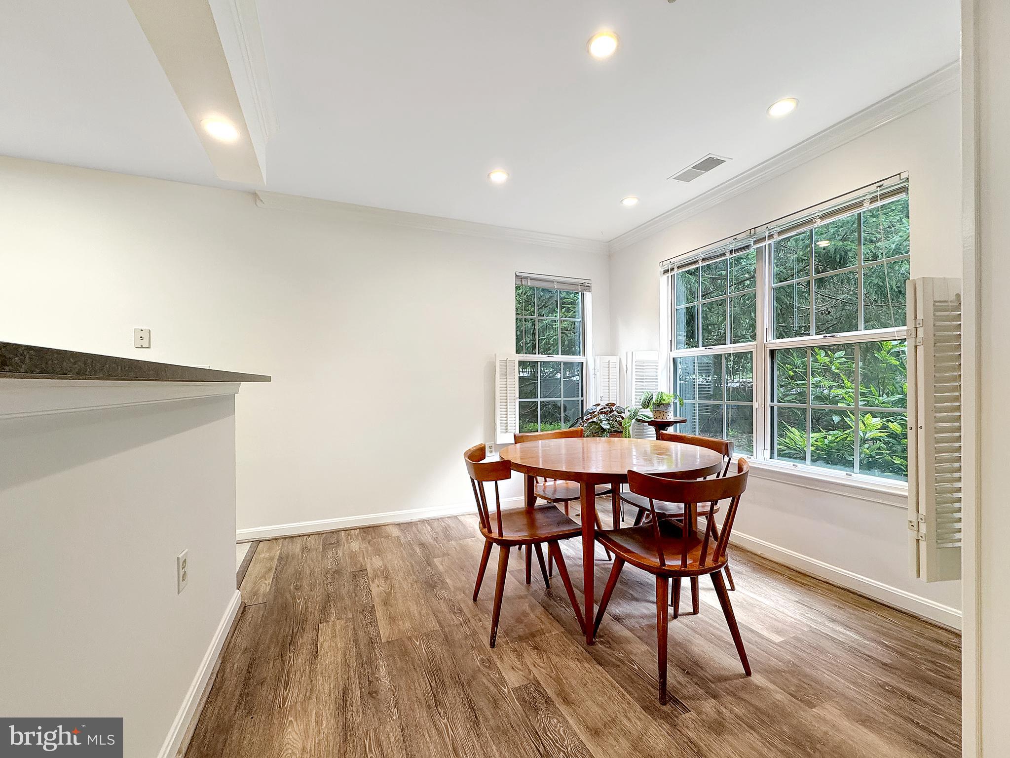 103 Timberbrook Lane, Unit 104 Gaithersburg, MD 20878 - Photo 20 of 35 a view of a dining room with furniture window and wooden floor