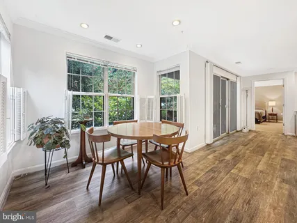a view of a dining room with furniture window and wooden floor