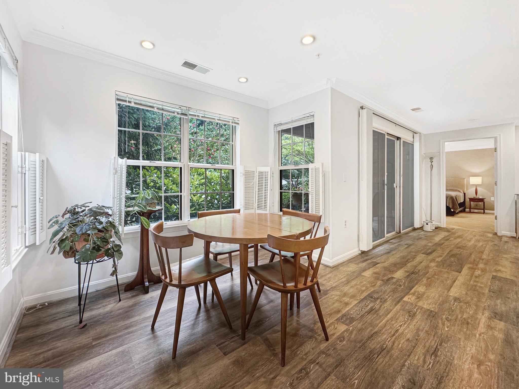103 Timberbrook Lane, Unit 104 Gaithersburg, MD 20878 - Photo 21 of 35 a view of a dining room with furniture window and wooden floor