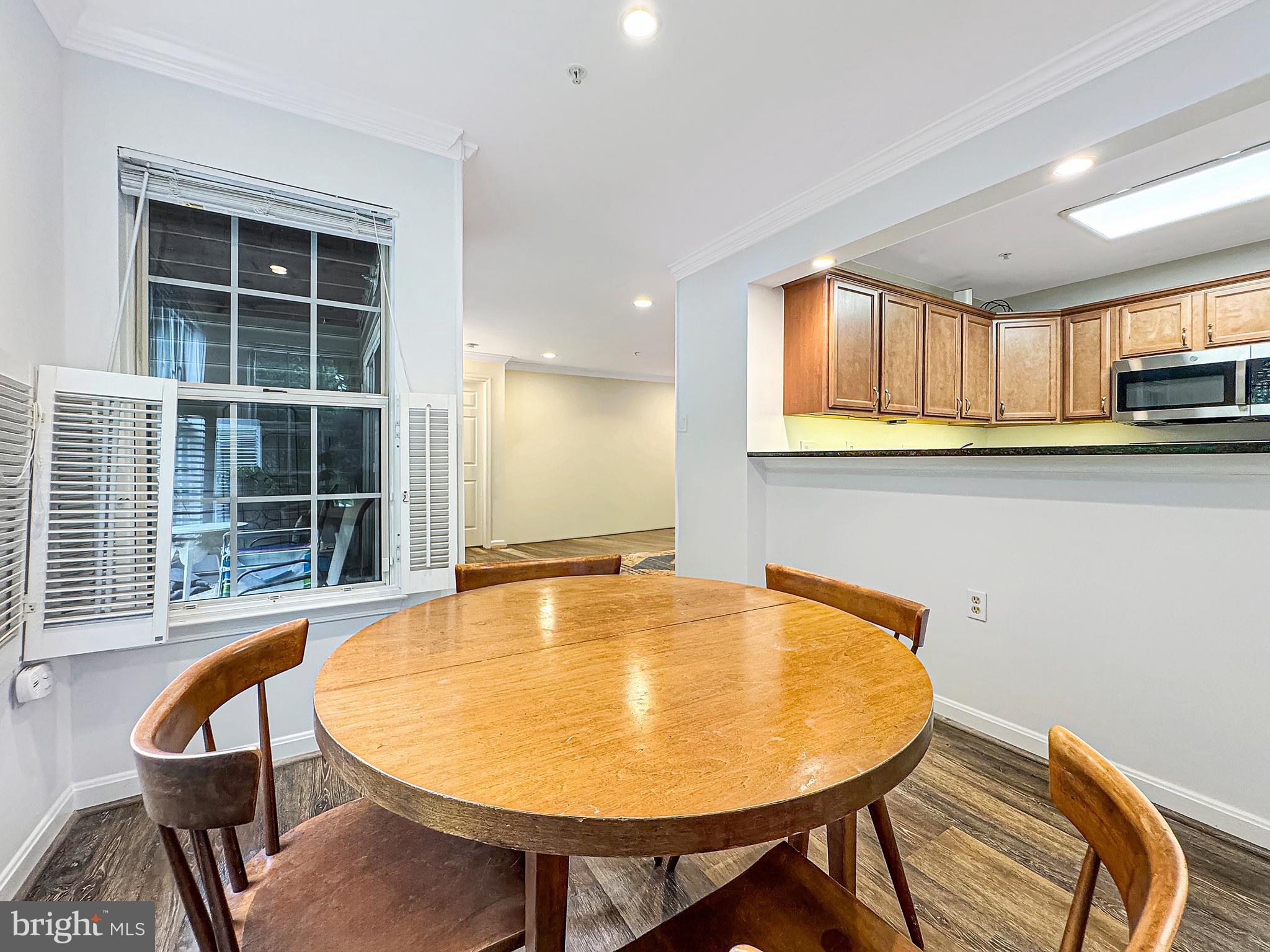 103 Timberbrook Lane, Unit 104 Gaithersburg, MD 20878 - Photo 22 of 35 a view of a dining room with furniture and window