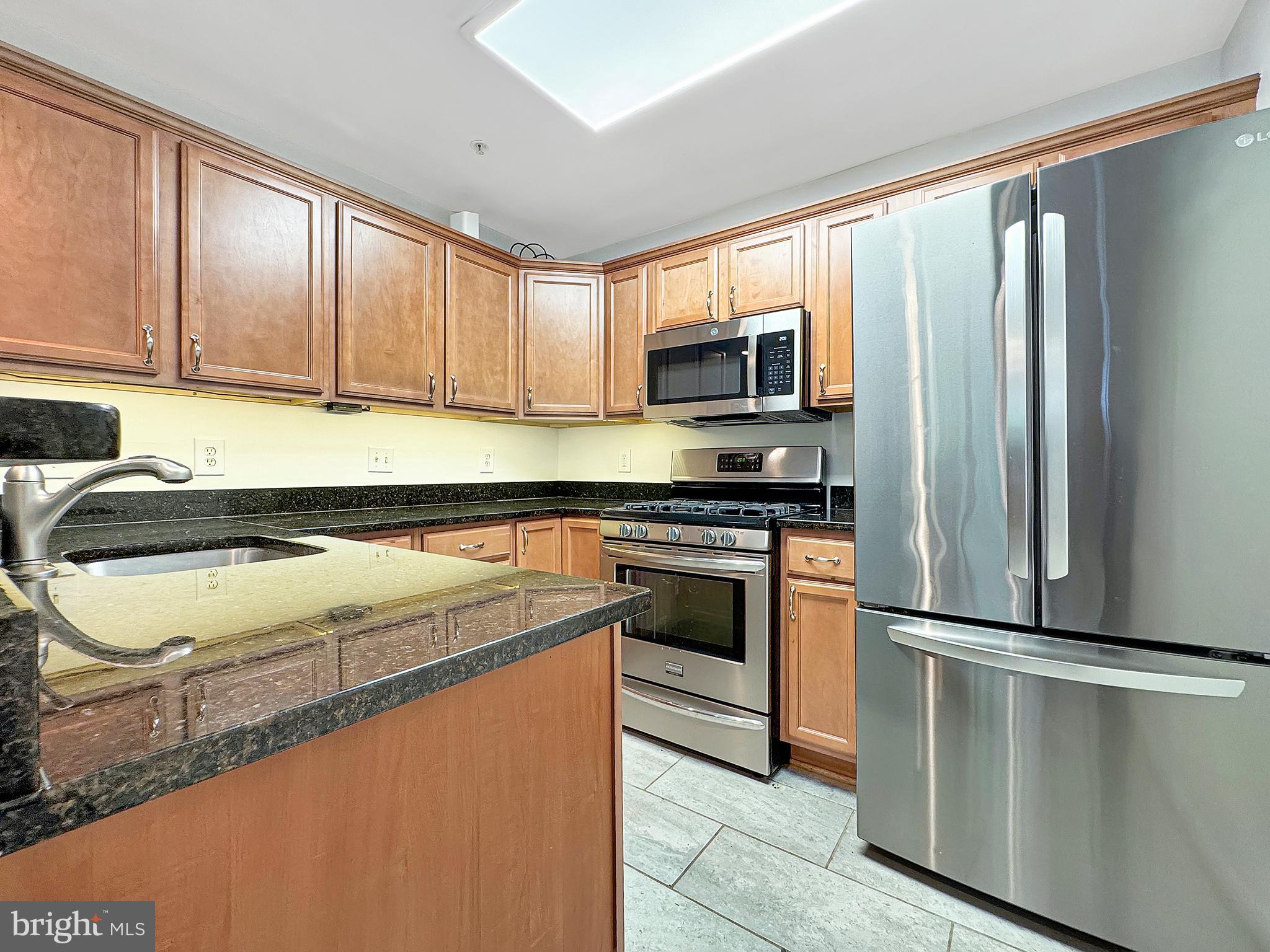 103 Timberbrook Lane, Unit 104 Gaithersburg, MD 20878 - Photo 24 of 35 a kitchen with a refrigerator sink and microwave