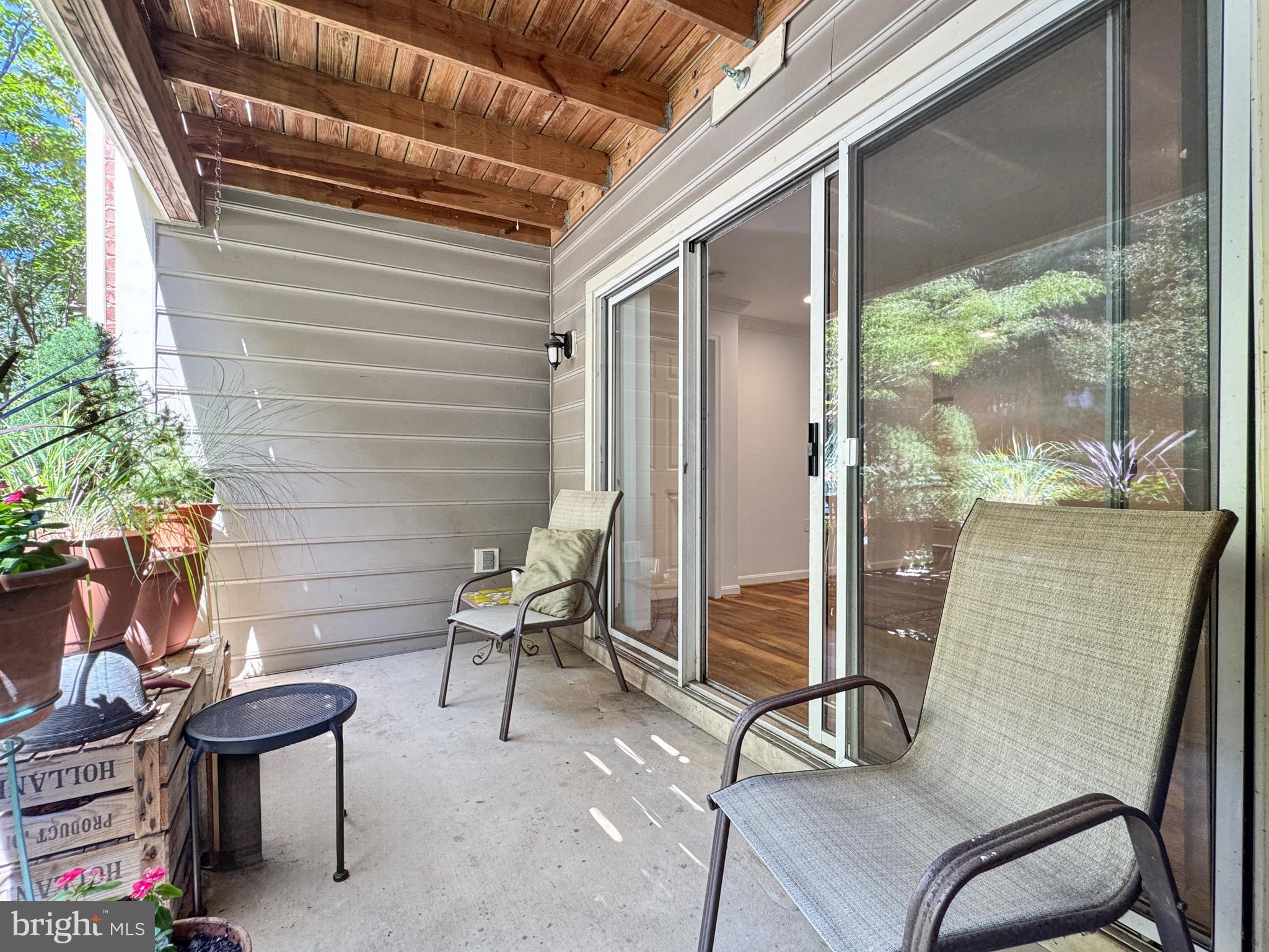 103 Timberbrook Lane, Unit 104 Gaithersburg, MD 20878 - Photo 27 of 35 a backyard of a house with barbeque oven table and chairs