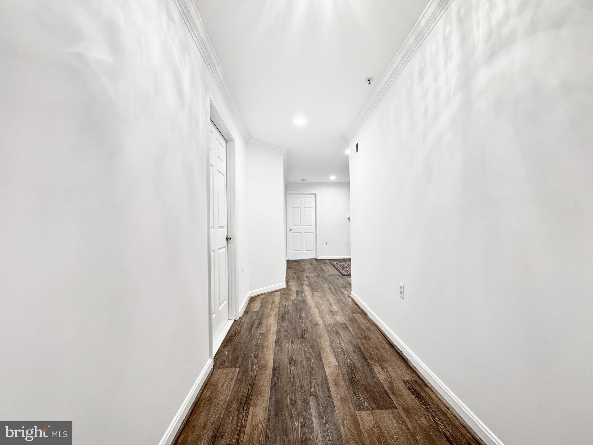 103 Timberbrook Lane, Unit 104 Gaithersburg, MD 20878 - Photo 3 of 35 a view of a hallway with wooden floor