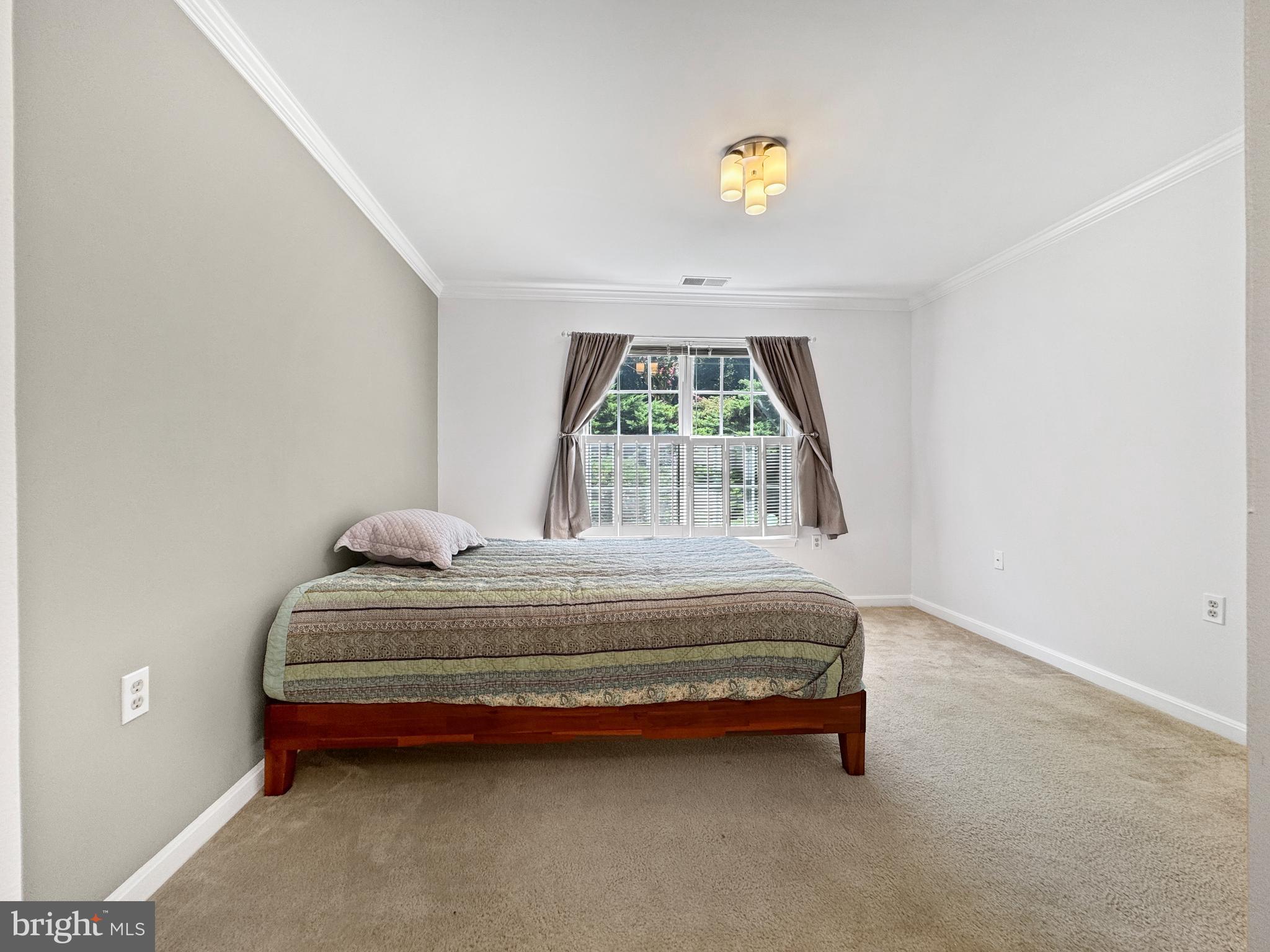 103 Timberbrook Lane, Unit 104 Gaithersburg, MD 20878 - Photo 10 of 35 a bedroom with a bed and a window