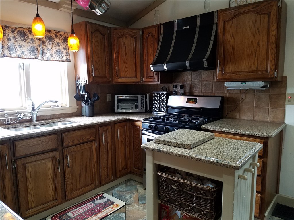 28 Yolande Place Woonsocket, RI 02895 - Photo 6 of 31 Renovated kitchen with excellent lighting; move-able island. Also you will find the laundry is located on this 1st floor!