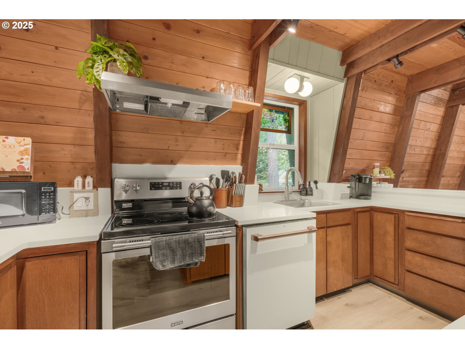 21760 East Tree Swallow Lane Rhododendron, OR 97049 - Photo 13 of 32 a kitchen with stainless steel appliances granite countertop a sink stove and cabinets
