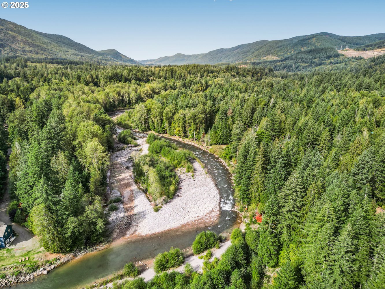 21760 East Tree Swallow Lane Rhododendron, OR 97049 - Photo 15 of 32 a view of a lush green hillside and a building