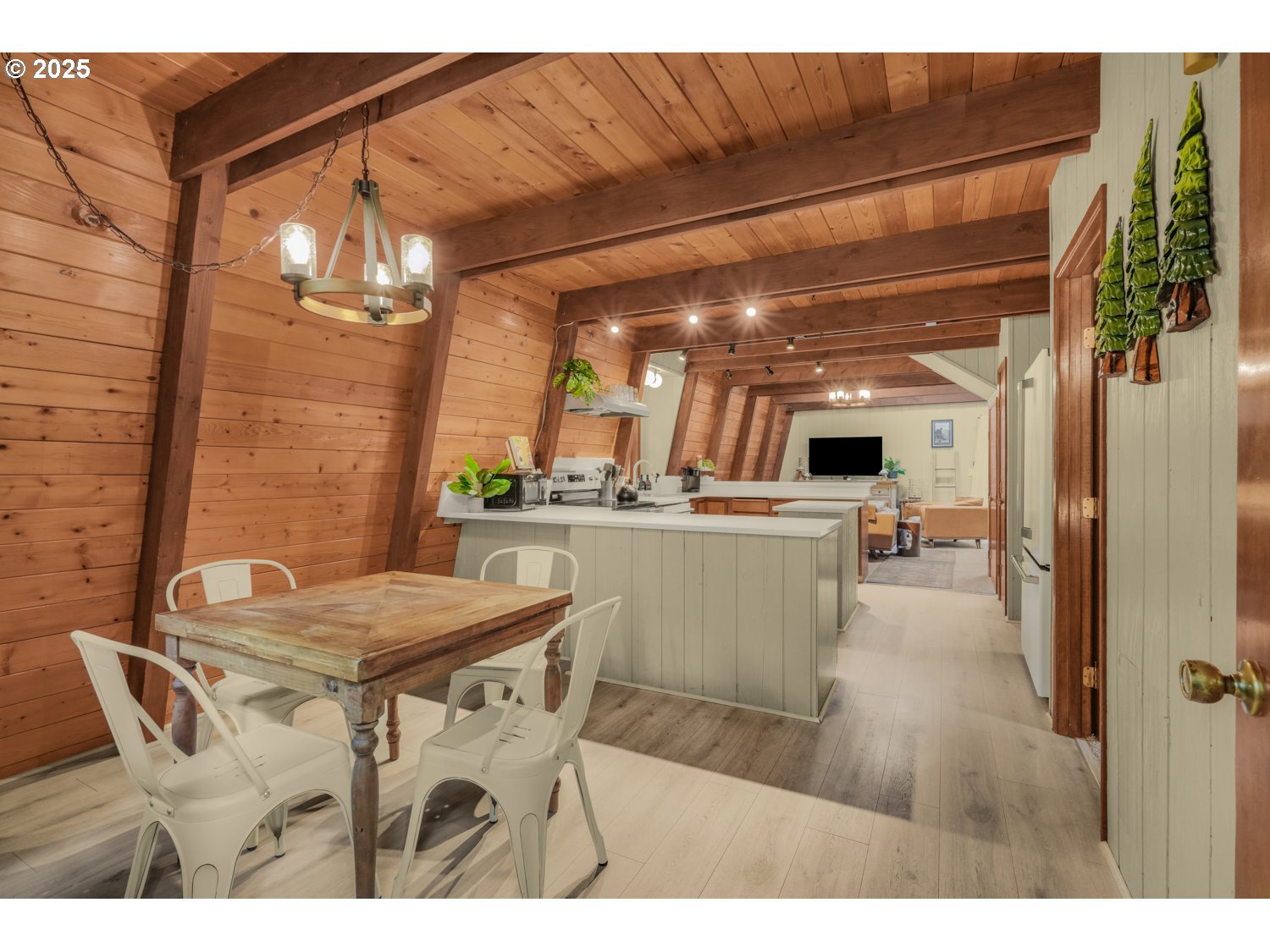 21760 East Tree Swallow Lane Rhododendron, OR 97049 - Photo 23 of 32 a view of a dining room with furniture and a chandelier