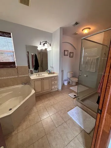 a spacious bathroom with a sink a mirror and bathtub