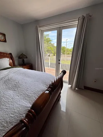 a bed sitting in a bedroom next to a window