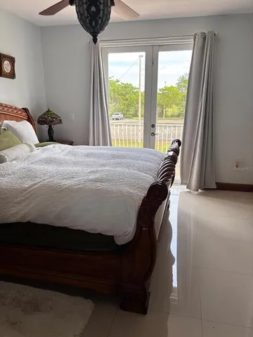 a bedroom with a bed and a large window