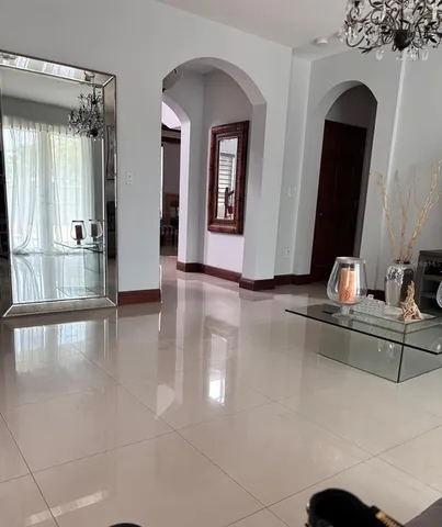 a view of hall way with mirror and furniture