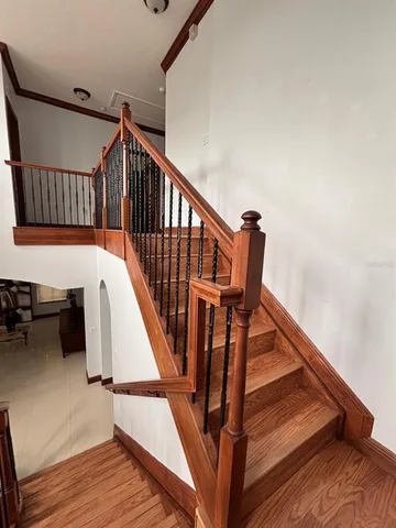 a view of entryway and hall with wooden floor