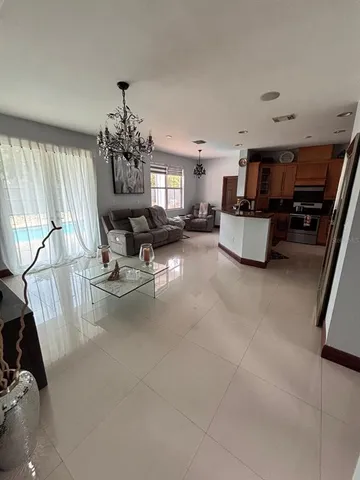 a living room with fireplace furniture and a chandelier