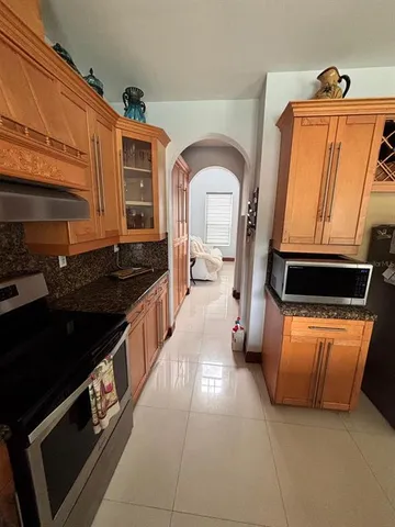 a kitchen with stainless steel appliances granite countertop a stove and a refrigerator