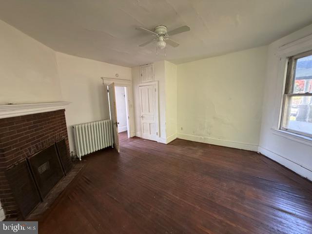 718 Woodlane Road Beverly, NJ 08010 - Photo 18 of 22 an empty room with windows a fireplace and wooden floor