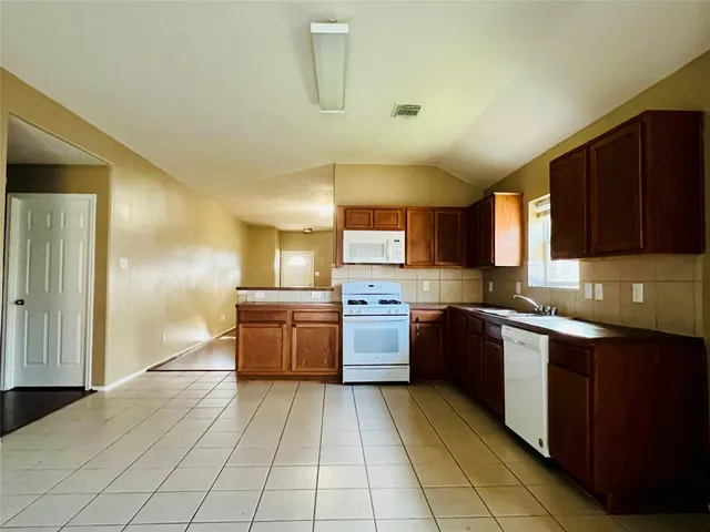 a kitchen with stainless steel appliances granite countertop a sink and cabinets