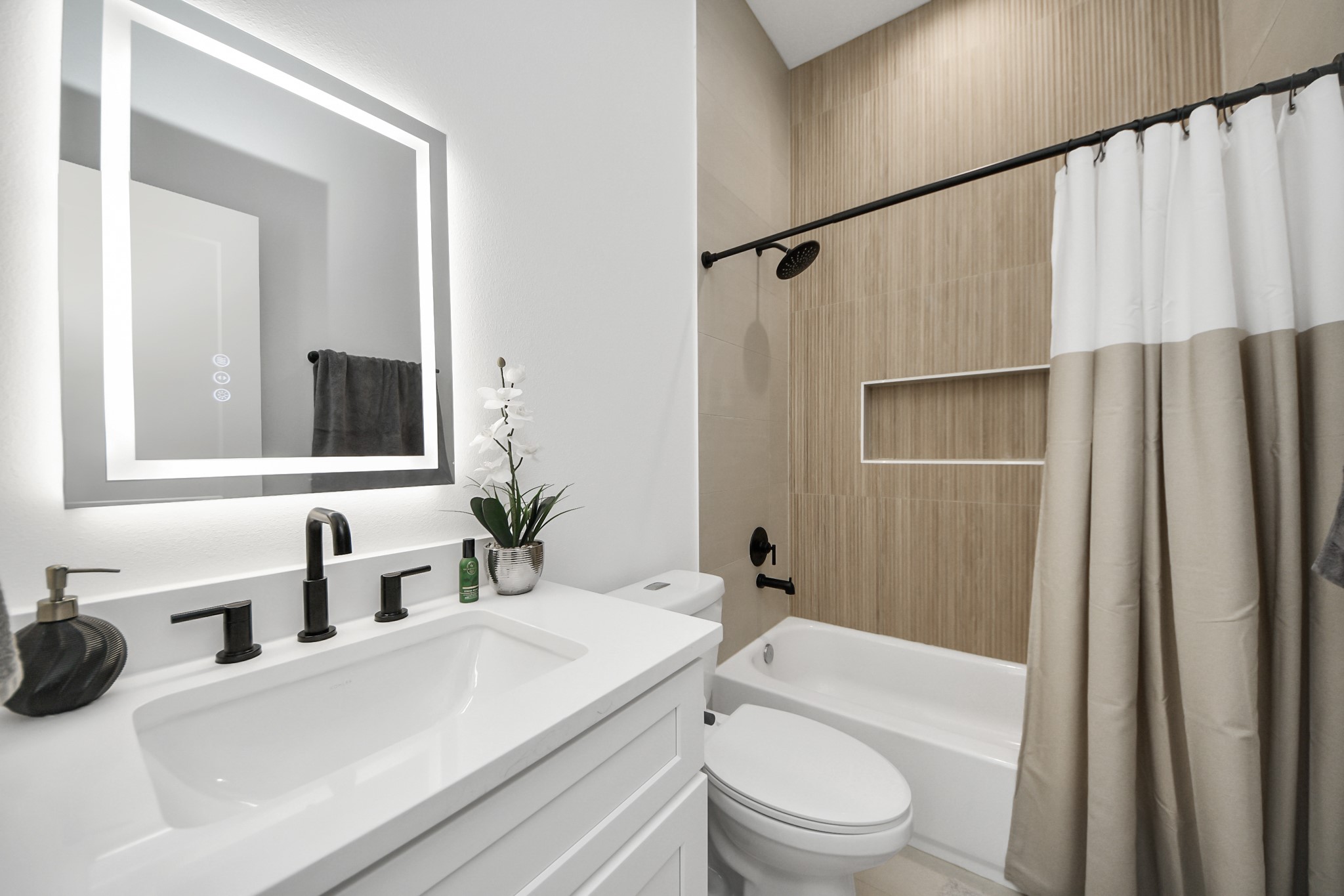 1044 West 17th Street Houston, TX 77008 - Photo 42 of 48 a bathroom with a sink a toilet a mirror and shower