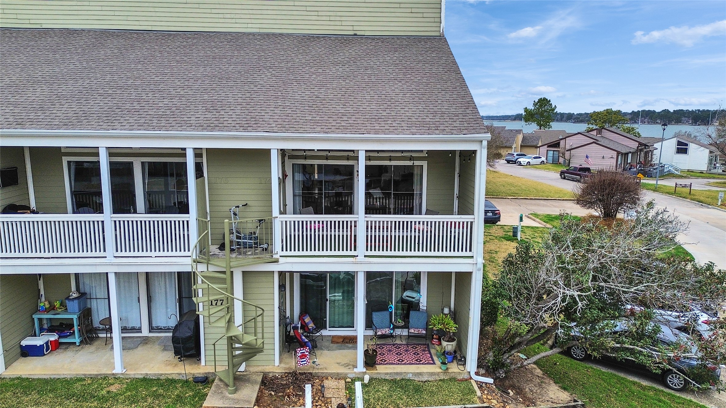 174 April Point Drive South Conroe, TX 77356 - Photo 37 of 38 a view of a house with a porch and a floor to ceiling window
